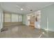 Sunroom with a view of the kitchen, light green walls, and terrazzo flooring at 3766 Benson N Ave, St Petersburg, FL 33713