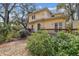 Backyard with a wooden deck, stone path, and abundant greenery, perfect for outdoor relaxation and entertaining at 4611 W Lowell Ave, Tampa, FL 33629