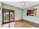 Dining area with tiled floor and view into the kitchen and with doors leading to the backyard at 4611 W Lowell Ave, Tampa, FL 33629