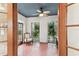 Bright sun room with brick floors, white walls, and large windows offering serene views of the surrounding greenery at 4611 W Lowell Ave, Tampa, FL 33629