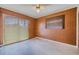 Bedroom with wood paneled walls and sliding glass doors at 5004 S Hesperides St, Tampa, FL 33611