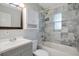 Clean bathroom with gray vanity, marble tile, and bathtub at 5418 10Th Ave S, Gulfport, FL 33707