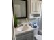 Bathroom featuring vanity, framed mirror, white cabinets and a decorative theme at 5418 10Th Ave S, Gulfport, FL 33707