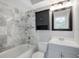 Updated bathroom with marble tile, a vanity, and a medicine cabinet at 5418 10Th Ave S, Gulfport, FL 33707