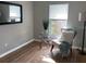 Cozy bedroom featuring wood floors, modern chair, decor, and natural light at 5418 10Th Ave S, Gulfport, FL 33707