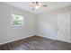 Comfortable bedroom featuring hardwood flooring, a ceiling fan and a window view at 5418 10Th Ave S, Gulfport, FL 33707