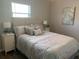 Inviting bedroom with a plush bed, side tables, lamps, and a large window at 5418 10Th Ave S, Gulfport, FL 33707