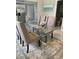 Dining area featuring a clear glass table, seating for six, and a view of the kitchen at 5418 10Th Ave S, Gulfport, FL 33707