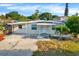 Cute bungalow style home with a carport and well-maintained lawn at 5418 10Th Ave S, Gulfport, FL 33707