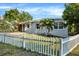 Charming home with a well-manicured front yard, picket fence, and inviting entrance at 5418 10Th Ave S, Gulfport, FL 33707