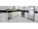 This kitchen features white cabinets, stainless steel appliances, and sleek countertops at 5418 10Th Ave S, Gulfport, FL 33707