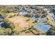 Aerial view of community amenities including tennis courts, basketball courts, pond, and playground at 5709 White Trillium Loop, Land O Lakes, FL 34639
