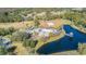 Aerial view of a community amenity center including a pool, playground, sand volleyball court, and pond at 5709 White Trillium Loop, Land O Lakes, FL 34639
