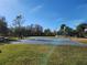 Well maintained outdoor basketball court with beautiful, sunny sky and mature landscaping at 5709 White Trillium Loop, Land O Lakes, FL 34639