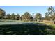 Outdoor basketball court with mature landscaping and covered pavilion seating area at 5709 White Trillium Loop, Land O Lakes, FL 34639