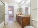 Bathroom with a granite vanity, decorative mirrors, and convenient access to a shower/tub combo at 5709 White Trillium Loop, Land O Lakes, FL 34639
