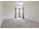 A spacious bedroom features carpet flooring and two windows for ample natural light at 5709 White Trillium Loop, Land O Lakes, FL 34639