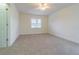 A well-lit carpeted bedroom with a ceiling fan and window offers a blank canvas for personalization at 5709 White Trillium Loop, Land O Lakes, FL 34639