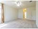 An ample bedroom features carpet flooring, a ceiling fan and interior access at 5709 White Trillium Loop, Land O Lakes, FL 34639