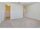 Neutral bedroom with walk-in closet and door to a hallway at 5709 White Trillium Loop, Land O Lakes, FL 34639