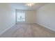 Neutral-toned bedroom with a window for natural light and soft carpeting at 5709 White Trillium Loop, Land O Lakes, FL 34639