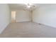 Spacious bedroom featuring neutral carpeting, a ceiling fan, and a walk-in closet at 5709 White Trillium Loop, Land O Lakes, FL 34639