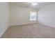Bedroom featuring a window and plush carpet flooring at 5709 White Trillium Loop, Land O Lakes, FL 34639