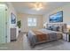 A staged bedroom with plush bedding, calming artwork, and plenty of natural light offers relaxation at 5709 White Trillium Loop, Land O Lakes, FL 34639