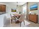 Cozy dining area featuring a wooden table, upholstered chairs, and stylish decor, with a window at 5709 White Trillium Loop, Land O Lakes, FL 34639