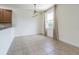 Bright dining area with tile flooring, a window, and space for a dining table and chairs at 5709 White Trillium Loop, Land O Lakes, FL 34639