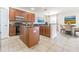 Well-equipped kitchen featuring dark wood cabinets, black appliances, and a breakfast bar with adjacent dining area at 5709 White Trillium Loop, Land O Lakes, FL 34639