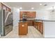 Kitchen with wood cabinets, stainless steel fridge, breakfast bar and decorative backsplash at 5709 White Trillium Loop, Land O Lakes, FL 34639