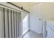 The laundry room offers a unique barn-style door with black hardware, as well as a standard doorway at 5709 White Trillium Loop, Land O Lakes, FL 34639