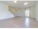 Bright and spacious living room with tile floors, a staircase, and ample natural light at 5709 White Trillium Loop, Land O Lakes, FL 34639