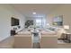 Staged living room with neutral tones and plush seating creates an inviting and comfortable atmosphere at 5709 White Trillium Loop, Land O Lakes, FL 34639