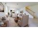 Bright living room with stylish furniture, decor, and a staircase leading to the next level at 5709 White Trillium Loop, Land O Lakes, FL 34639