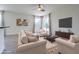 Bright living room features tile floors, recessed lights, and glass doors to backyard at 5709 White Trillium Loop, Land O Lakes, FL 34639