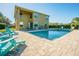 Backyard pool with patio seating and grill area in a fully fenced yard with mature landscaping at 5709 White Trillium Loop, Land O Lakes, FL 34639