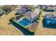 Aerial view of a fenced-in pool and patio area, with outdoor seating, in the backyard of a residential home at 5709 White Trillium Loop, Land O Lakes, FL 34639