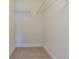Empty walk-in closet with shelving and carpeted flooring at 5709 White Trillium Loop, Land O Lakes, FL 34639