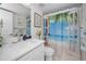 Clean bathroom with white vanity and beach-themed shower curtain at 5817 Park N St # 204, St Petersburg, FL 33709