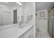 Bright bathroom features white cabinets, a tile shower and a modern style sink at 5817 Park N St # 204, St Petersburg, FL 33709