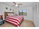 Bright bedroom with red and white striped bedding and wood flooring at 5817 Park N St # 204, St Petersburg, FL 33709