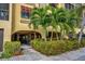Attractive building entrance with lush landscaping and walkway at 5817 Park N St # 204, St Petersburg, FL 33709