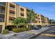 Beautiful condo complex with covered parking, lush landscaping, and mature palm trees at 5817 Park N St # 204, St Petersburg, FL 33709
