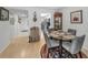 Cozy dining room adjacent to the kitchen with wood floors and a round glass table at 5817 Park N St # 204, St Petersburg, FL 33709