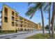 Condominium building with multiple floors, balconies, ground floor garages, and ample parking at 5817 Park N St # 204, St Petersburg, FL 33709