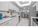 Bright kitchen, white cabinets, quartz countertops, stainless steel appliances at 5817 Park N St # 204, St Petersburg, FL 33709