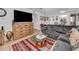 Cozy living room, sectional sofa, wood dresser, and large TV at 5817 Park N St # 204, St Petersburg, FL 33709
