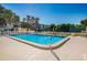 Inviting community pool with lounge chairs and nearby tennis court at 5817 Park N St # 204, St Petersburg, FL 33709